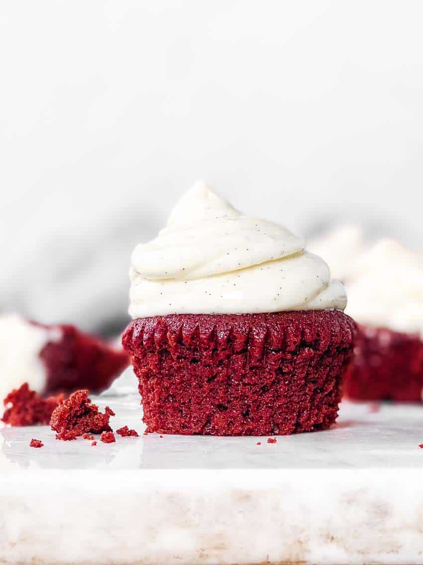 red velvet cupcake with cream cheese frosting on countertop
