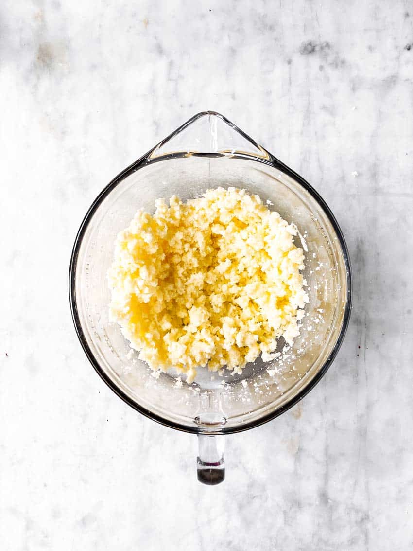 half creamed butter and sugar in glass bowl