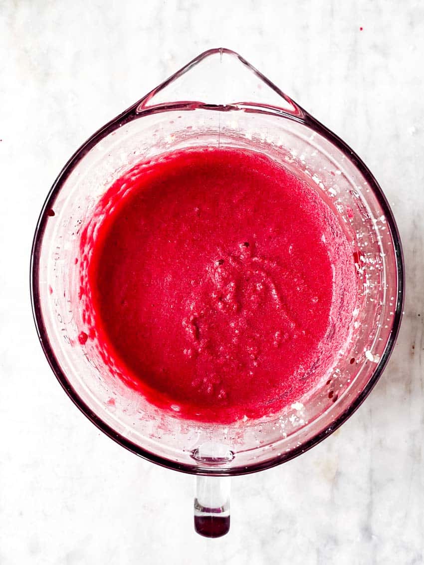 combined wet ingredients for red velvet cupcakes in glass bowl