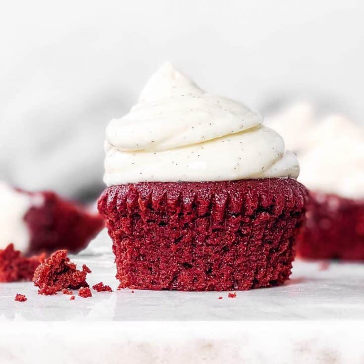 red velvet cupcake with cream cheese frosting on countertop