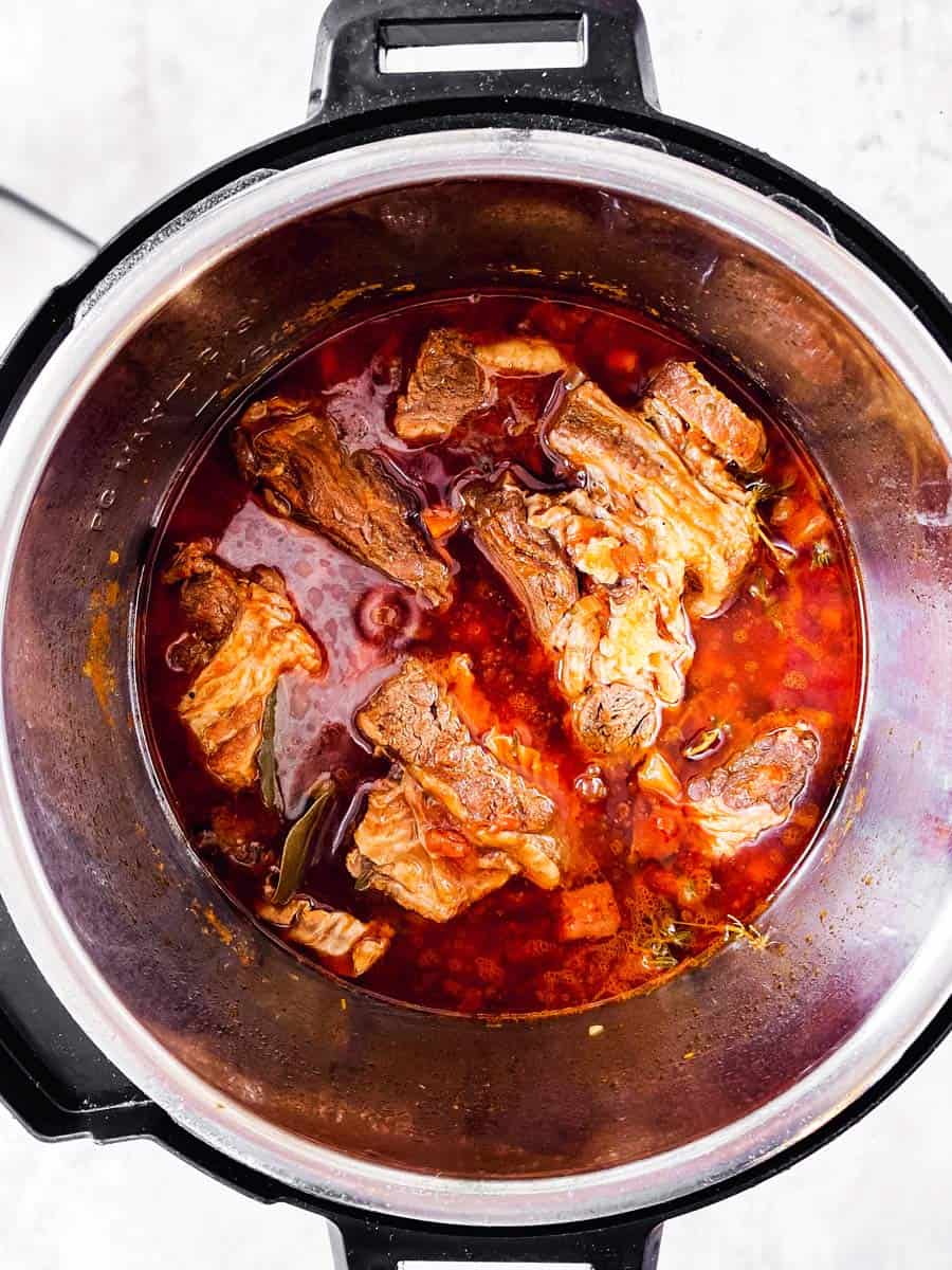 overhead view of instant pot with cooked short ribs