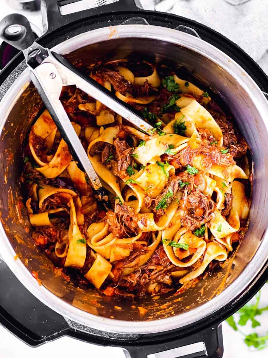 overhead view of instant pot with short rib ragu and pappardelle