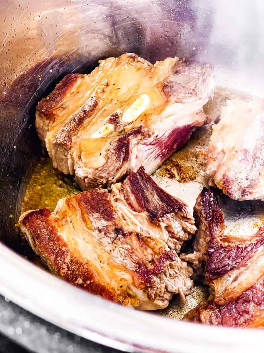 close up photo of browned short ribs in instant pot