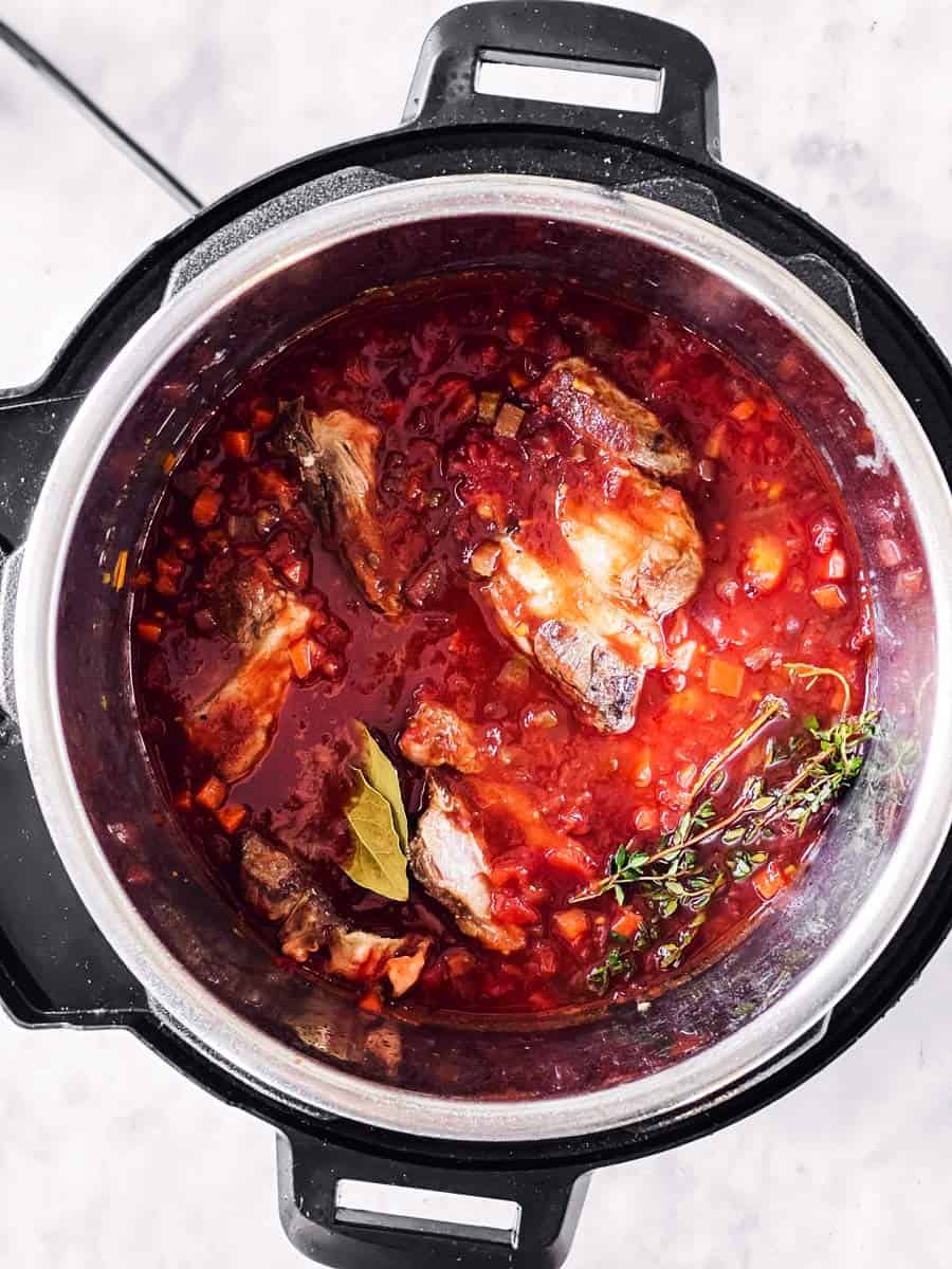 overhead view of instant pot with uncooked short rib ragu