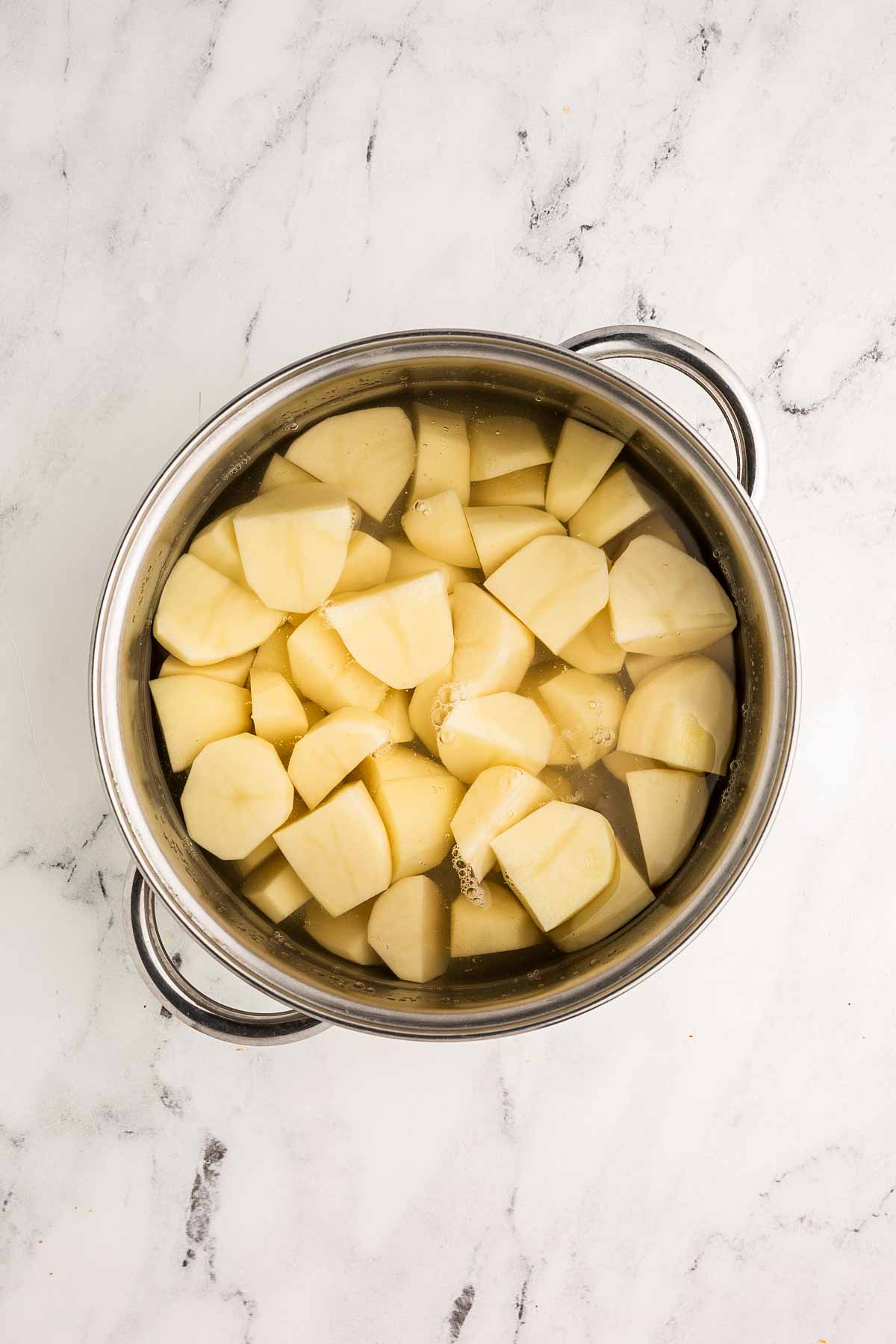overhead view of pot filled with water and potatoes