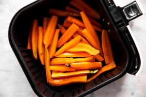 raw carrots in air fryer basket