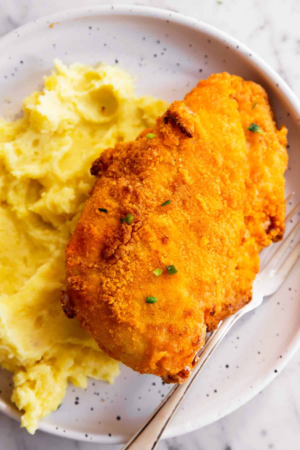 air fryer fried chicken and mashed potatoes on plate with fork