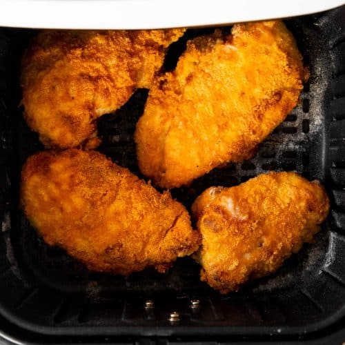 overhead view of fried chicken in air fryer basket