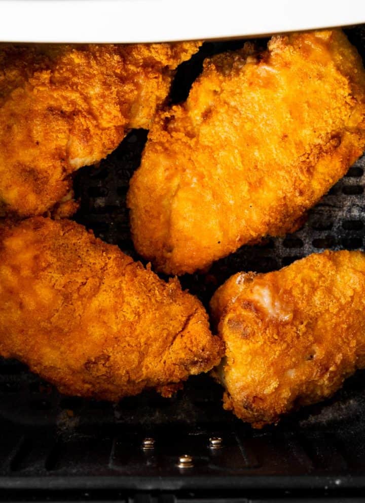 overhead view of fried chicken in air fryer basket
