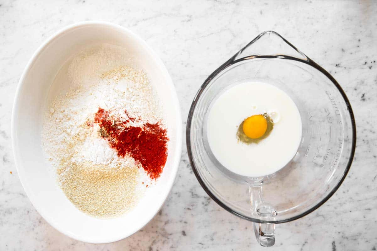 ingredients prepared for breading chicken in two bowls