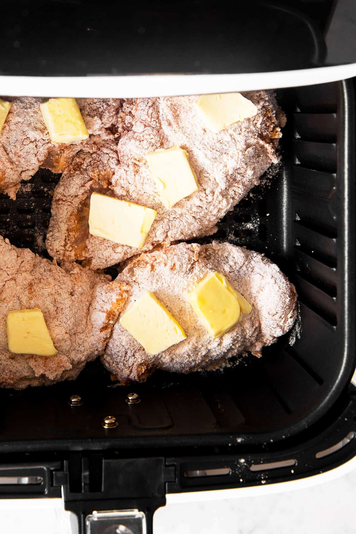 raw breaded chicken with butter in air fryer