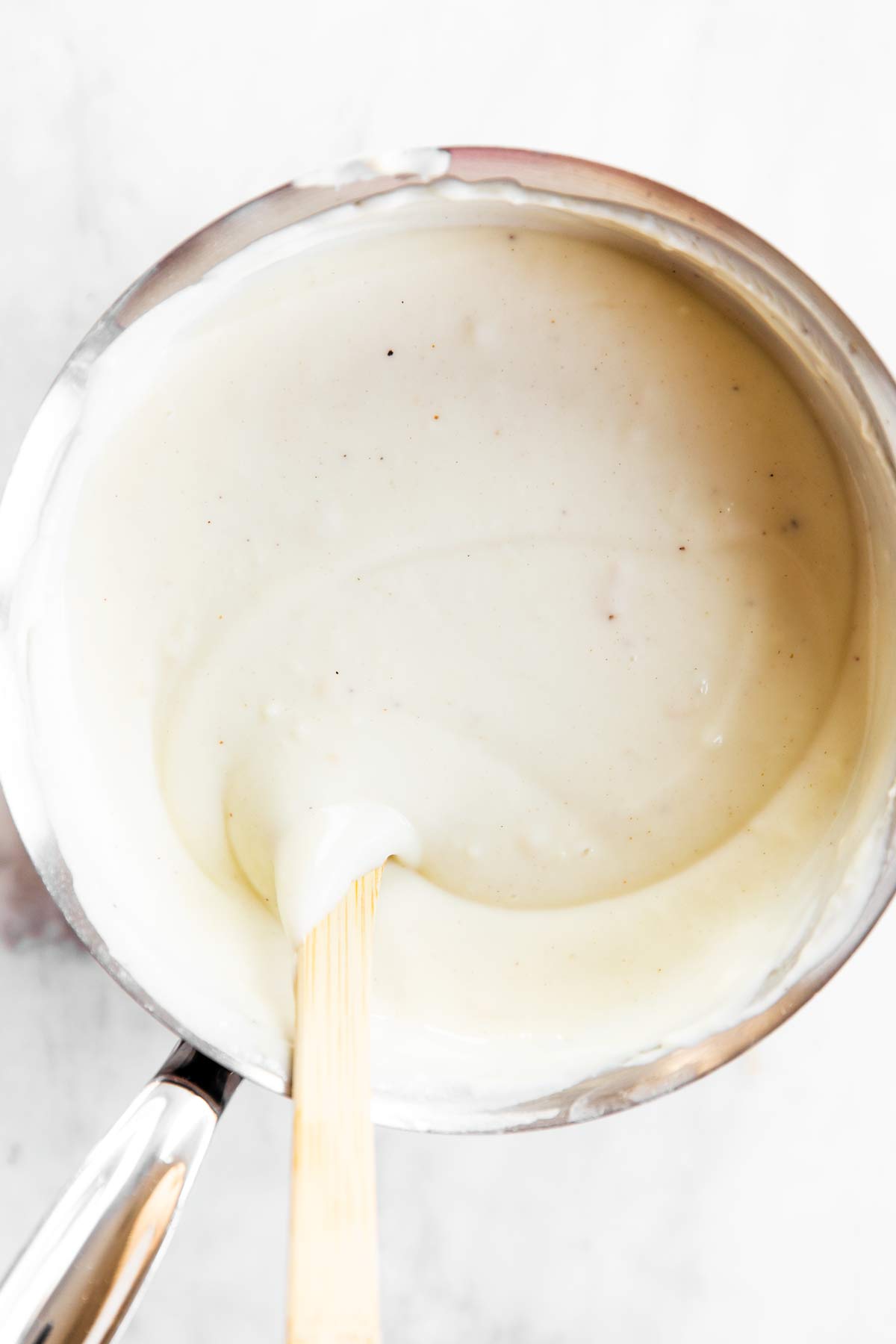 overhead view of Béchamel sauce in saucepan