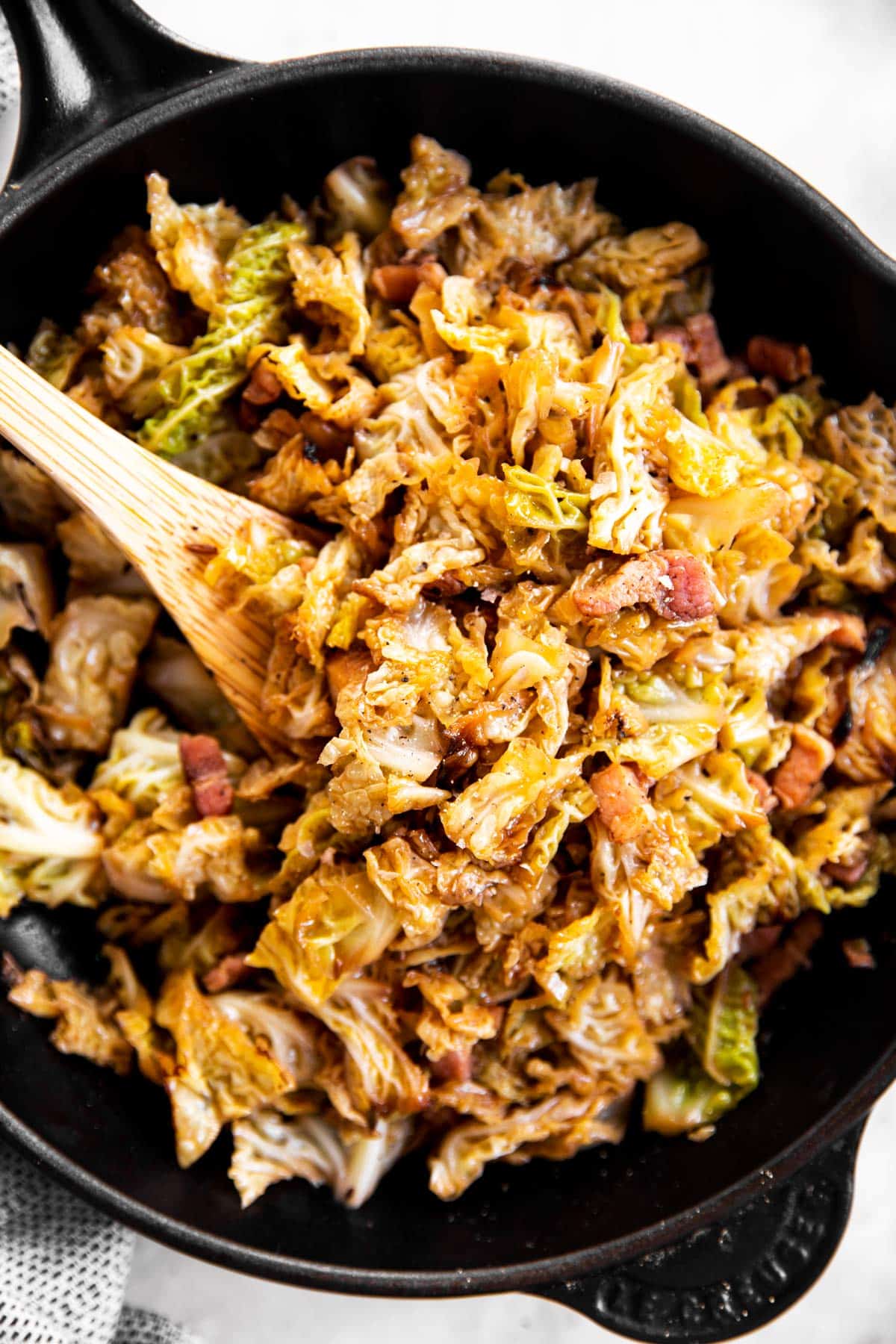 bacon braised cabbage in black cast iron skillet