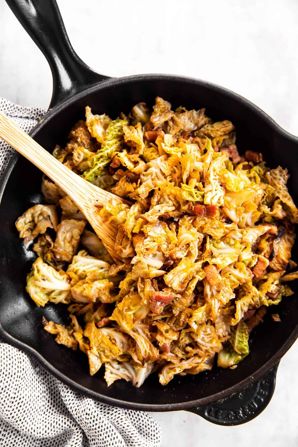 overhead view of black cast iron skillet with braised cabbage inside