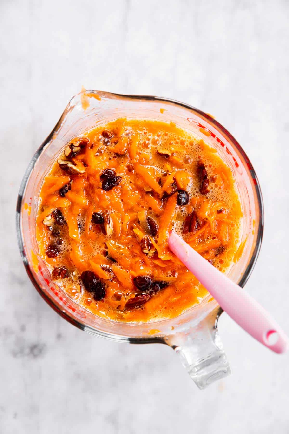 combined wet ingredients for carrot muffins in glass measuring jug