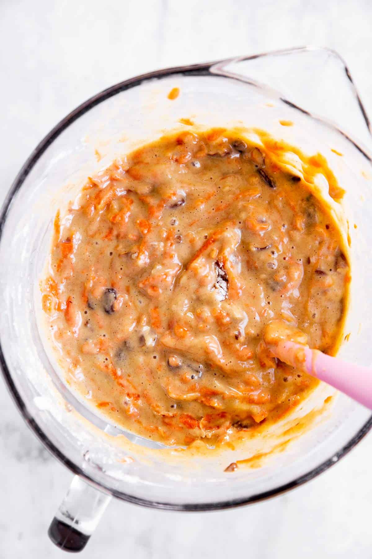 carrot muffin batter in glass batter bowl