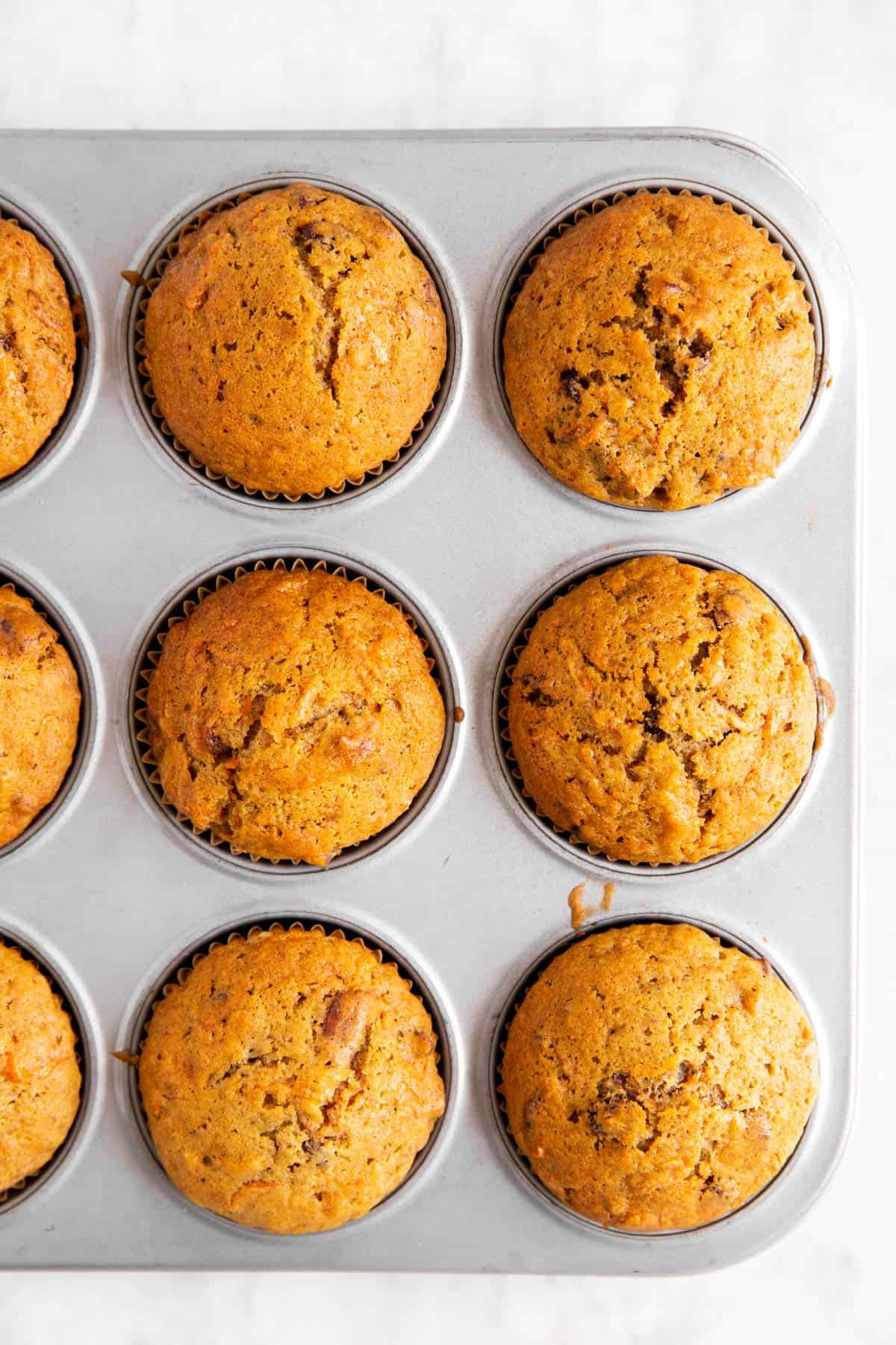 overhead view of carrot muffins in muffin pan