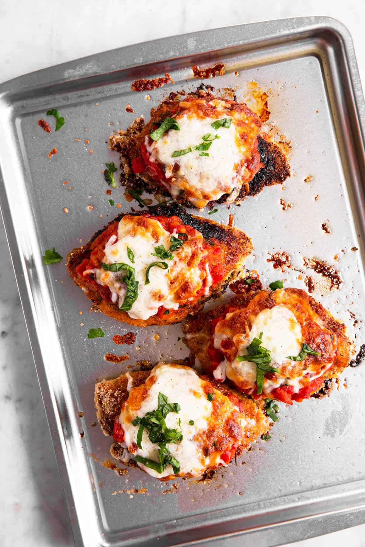 baked chicken parmesan on sheet pan