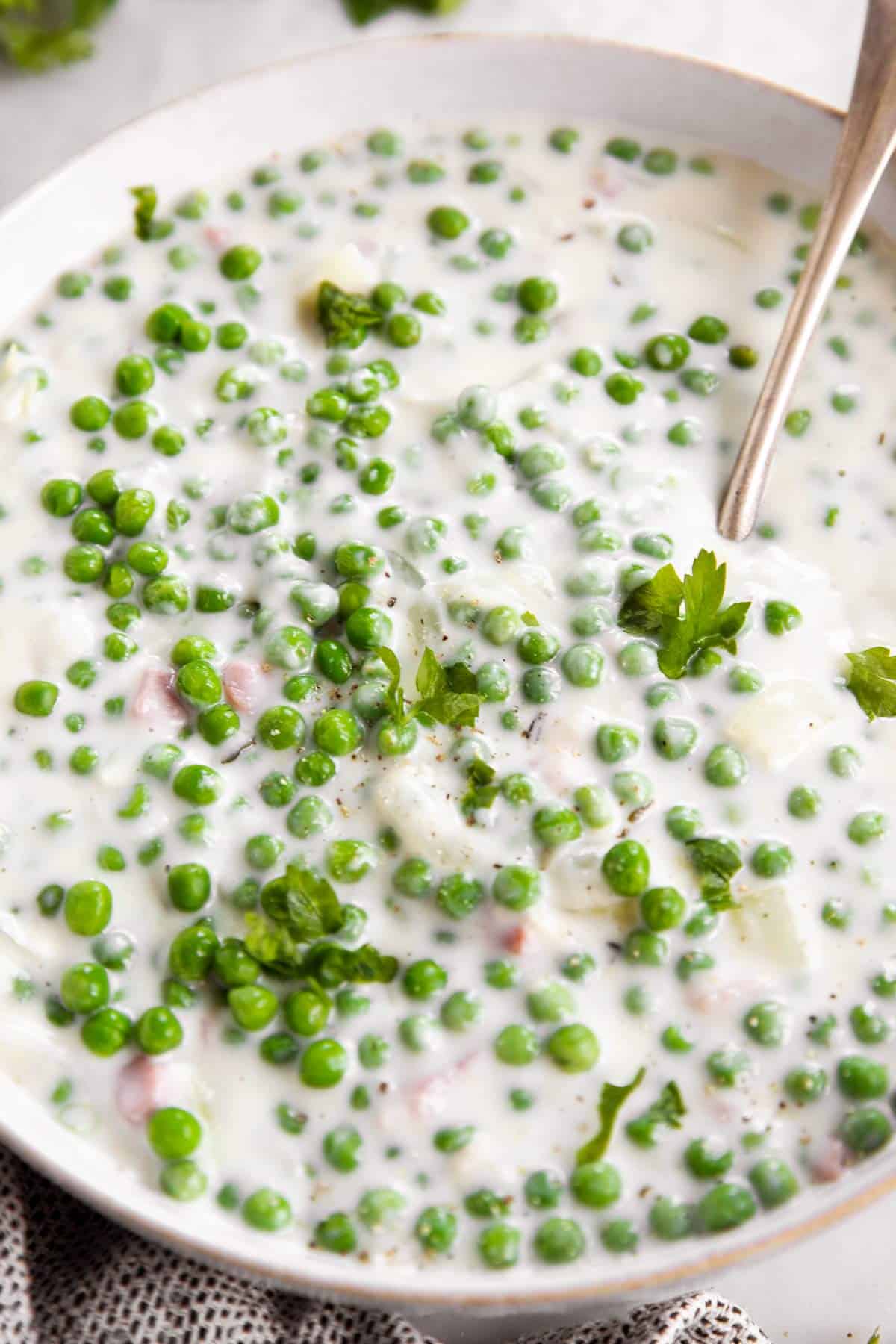 white bowl filled with creamed peas