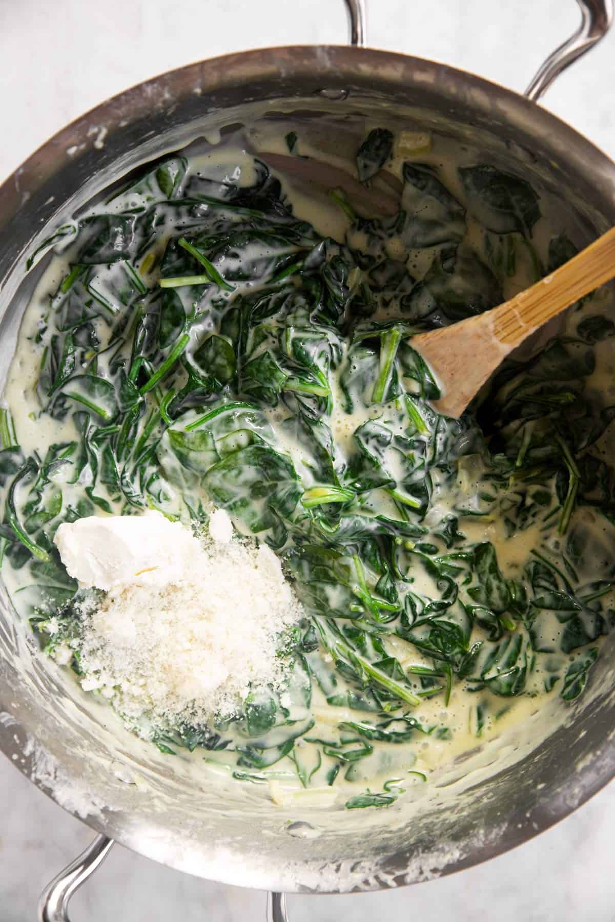 creamed spinach with cream cheese and grated parmesan in skillet