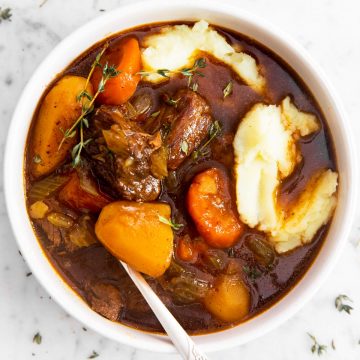 overhead view of white bowl filled with mashed potatoes and instant pot Irish stew