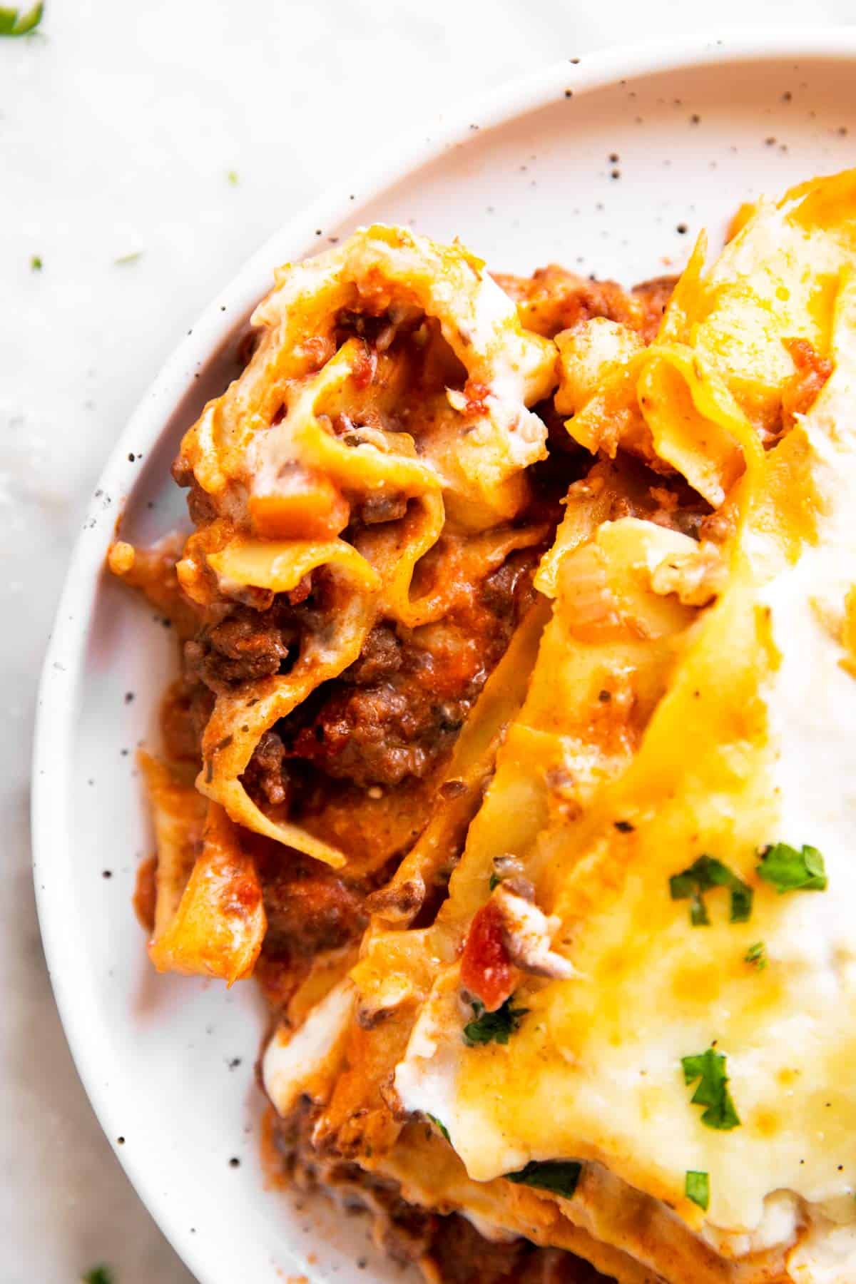 overhead view of lasagna on white plate