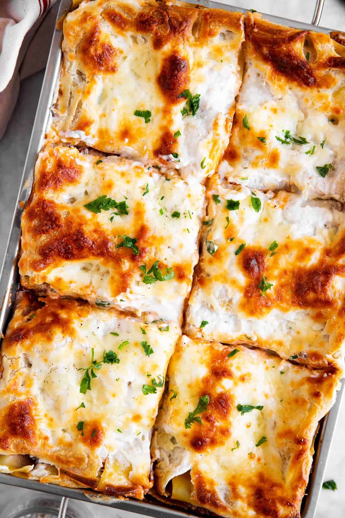 overhead view of sliced lasagna in casserole dish