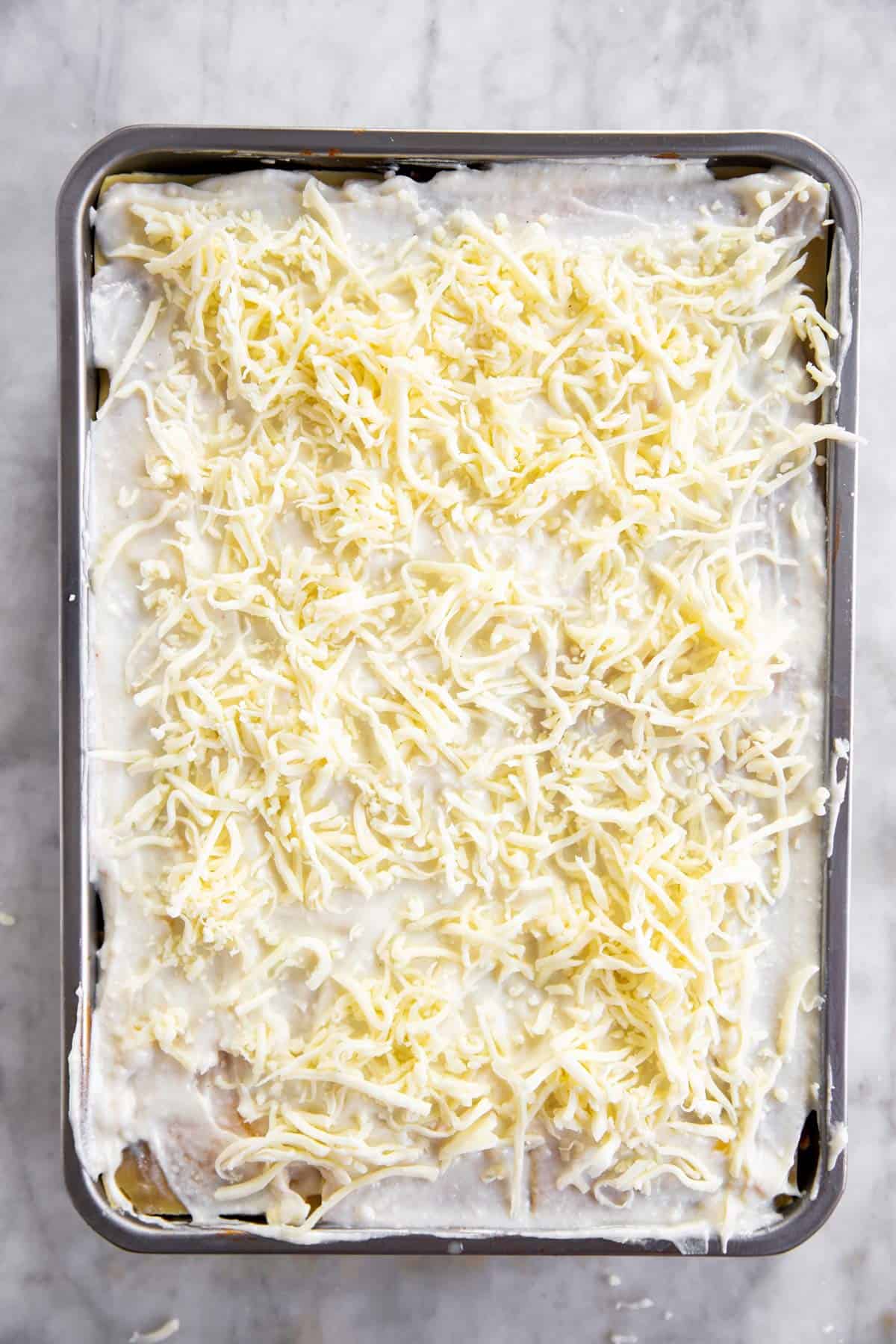 casserole dish with last layer of béchamel sauce