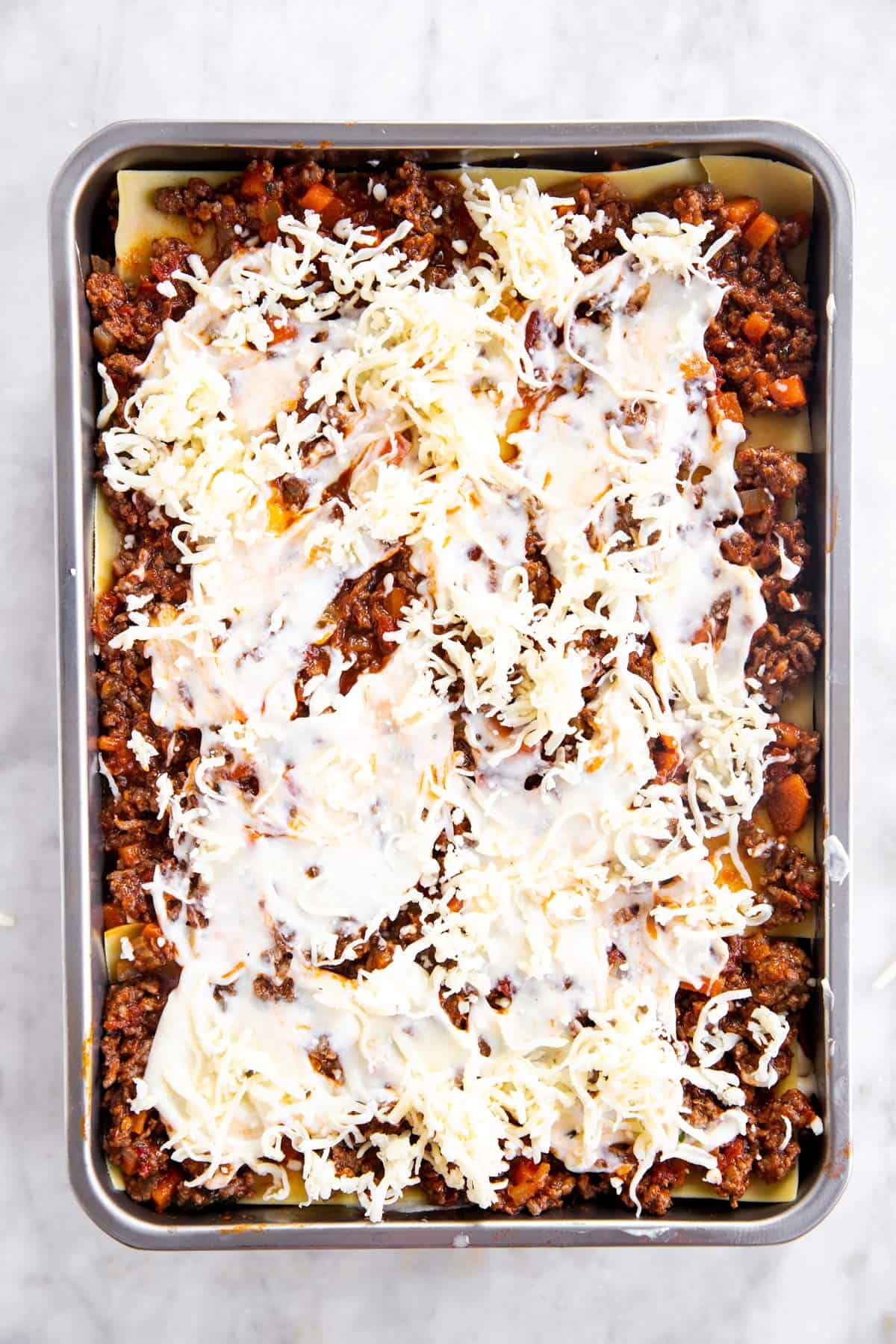 casserole dish with third layer of béchamel sauce