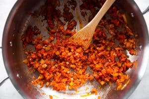 sofrito with tomato paste in skillet