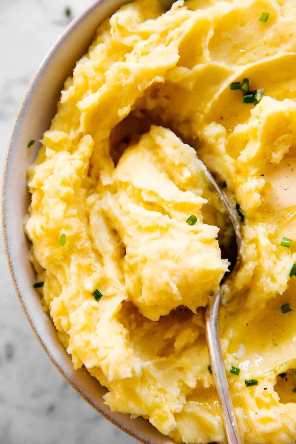 close up of spoon in mashed potatoes