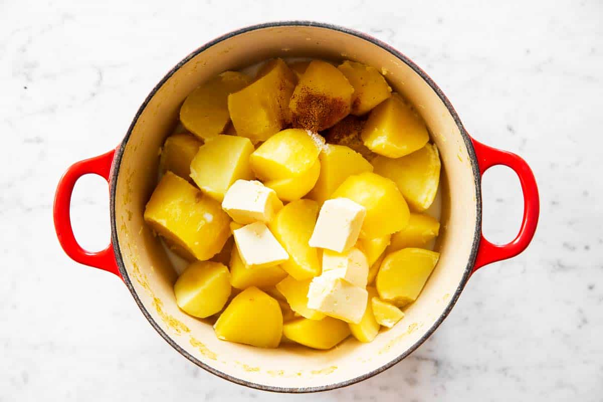 pot with cooked potatoes with butter and milk