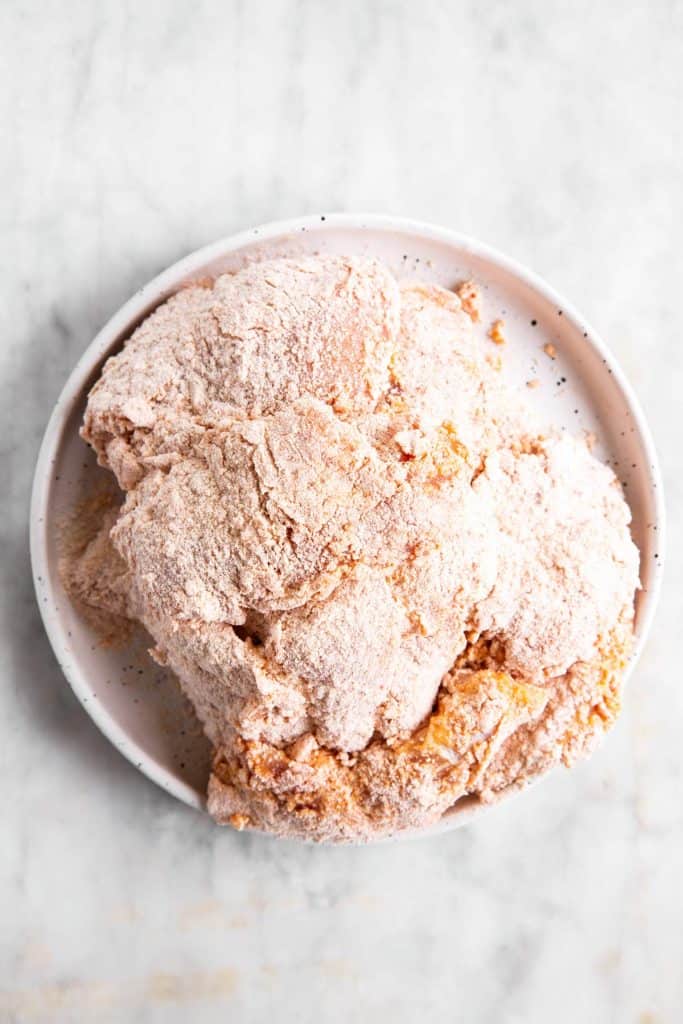 pile of breaded chicken breast on white plate