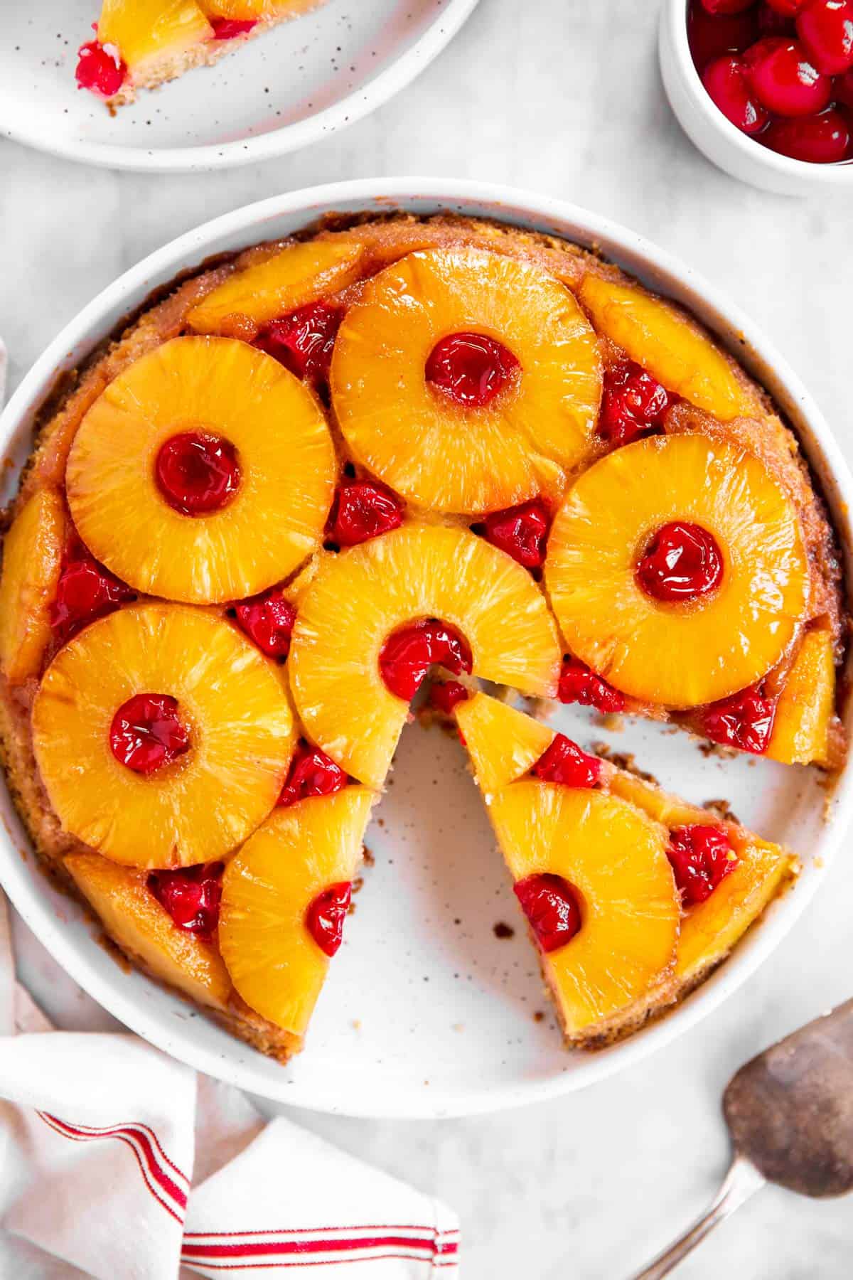 overhead view of sliced pineapple upside down cake on marble surface