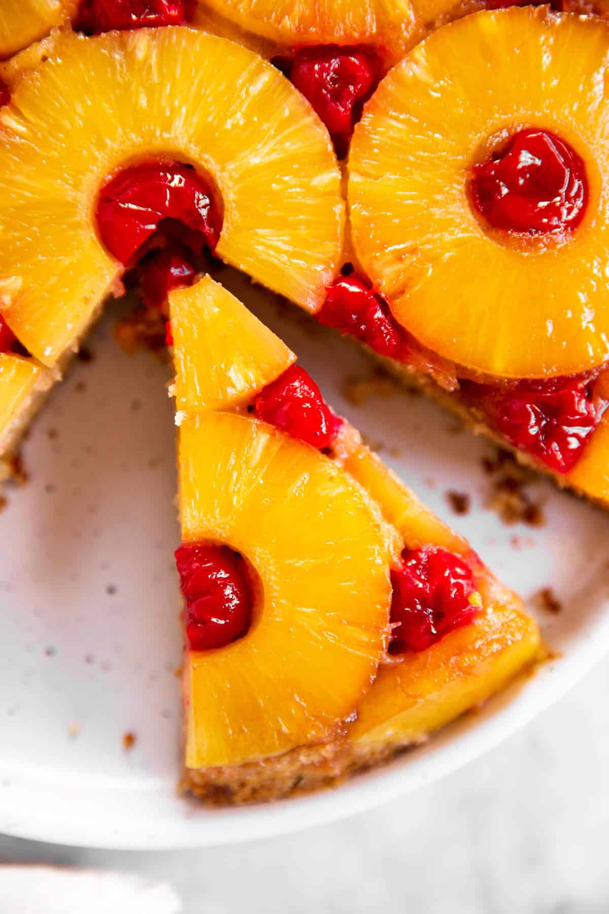 close up photo of a slice of pineapple upside down cake