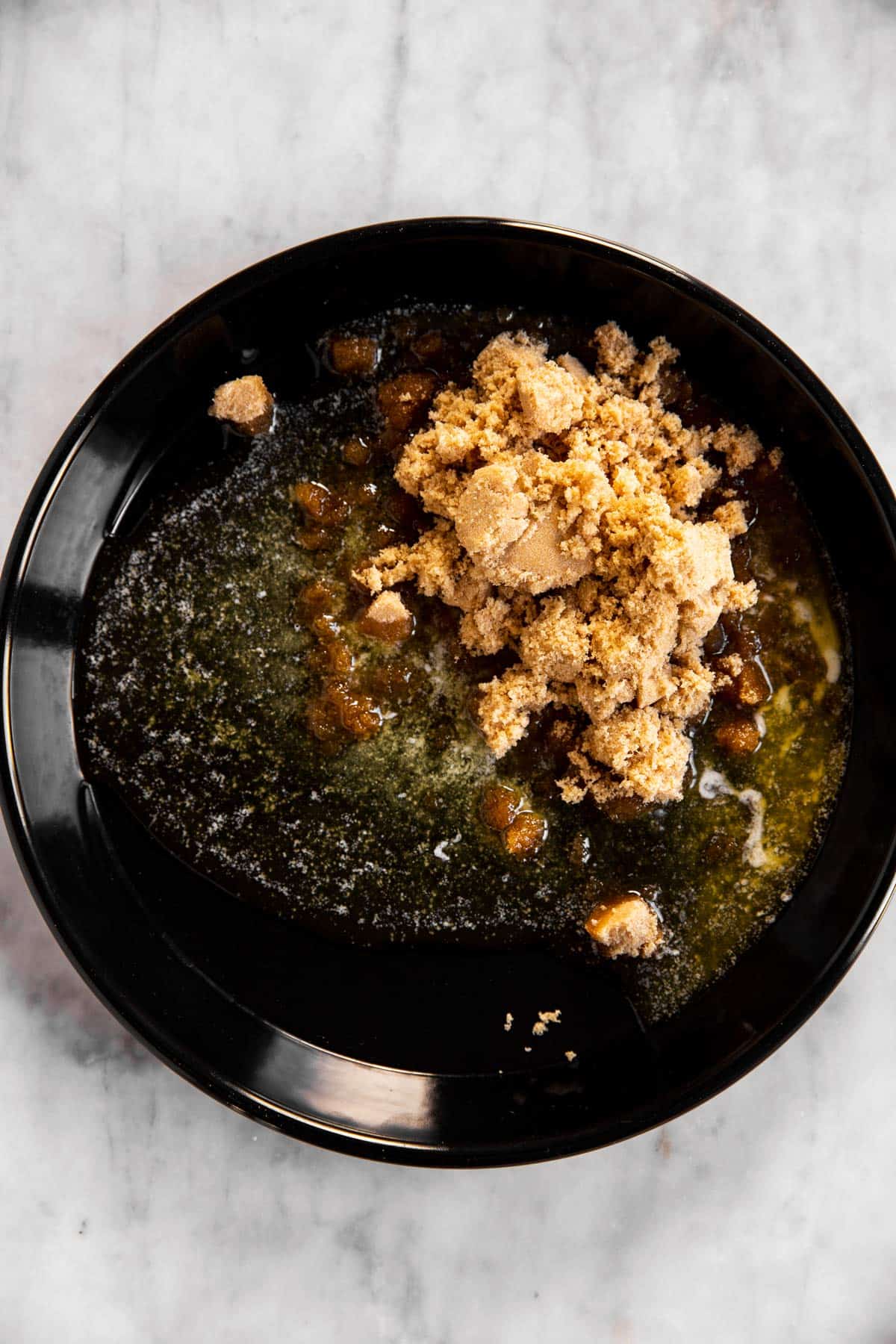 brown sugar and butter in black cake pan