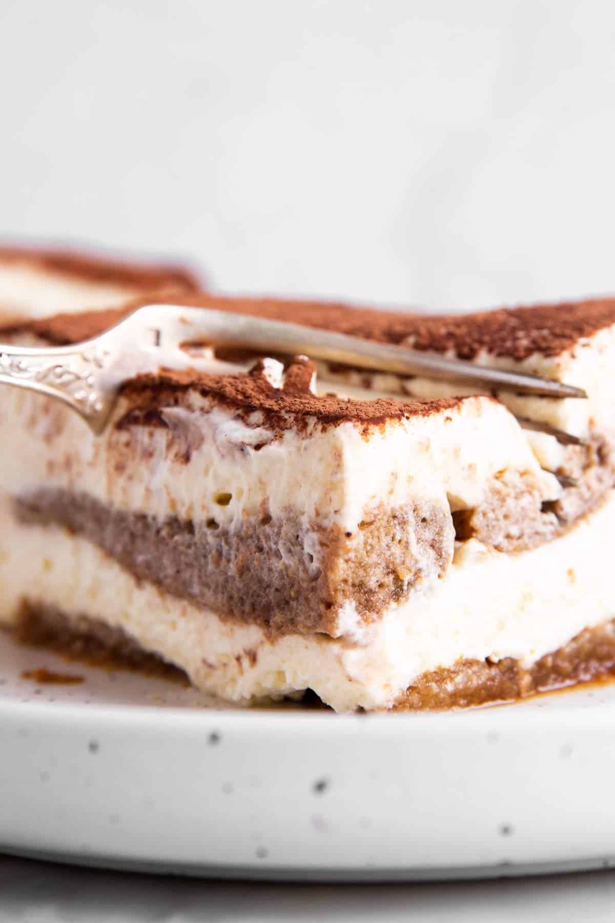 fork digging into slice of Tiramisu