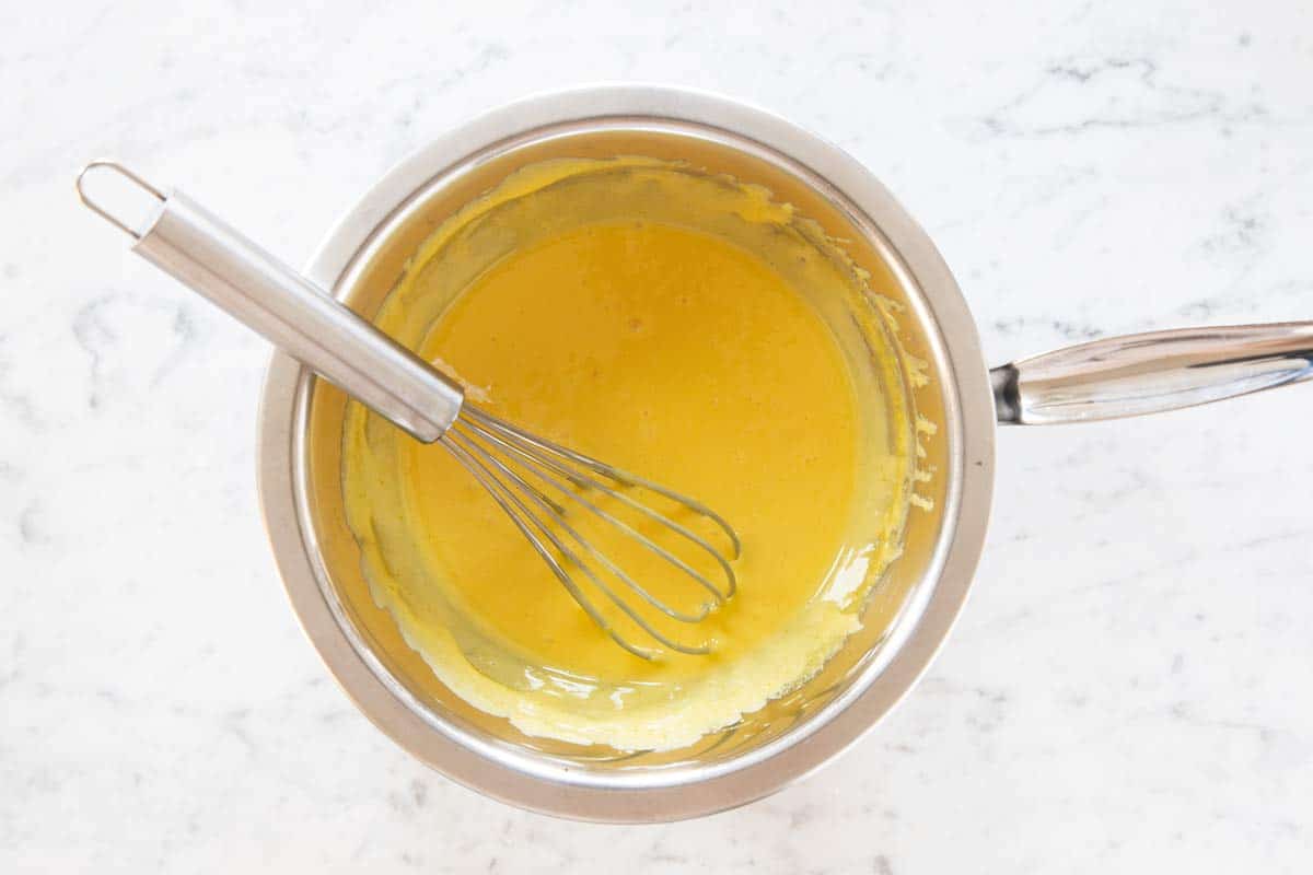 double boiler with tempered egg yolks in bowl