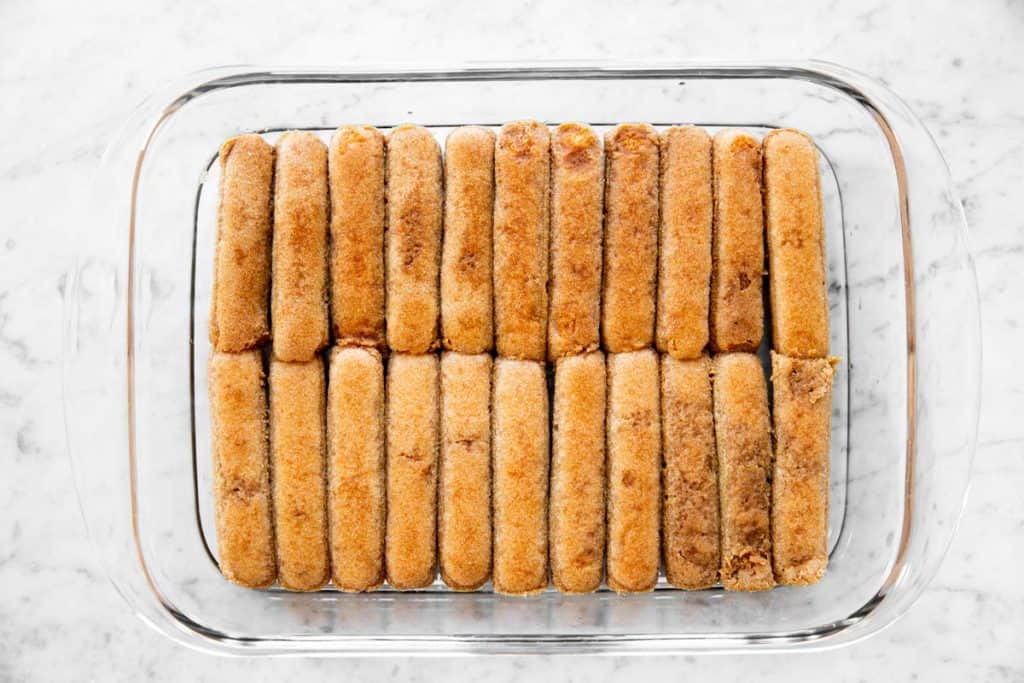 pan lined with coffee-soaked ladyfinger biscuits