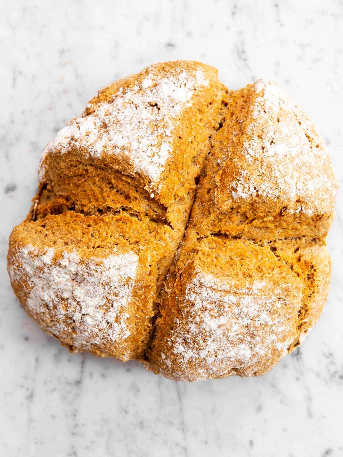 baked Irish soda bread on marble surface