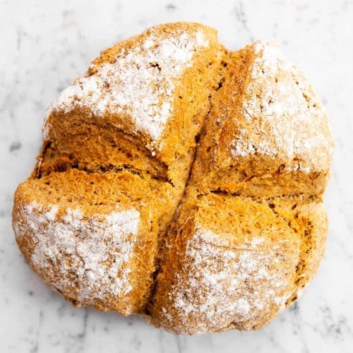 overhead view of baked Irish soda bread on marble surface
