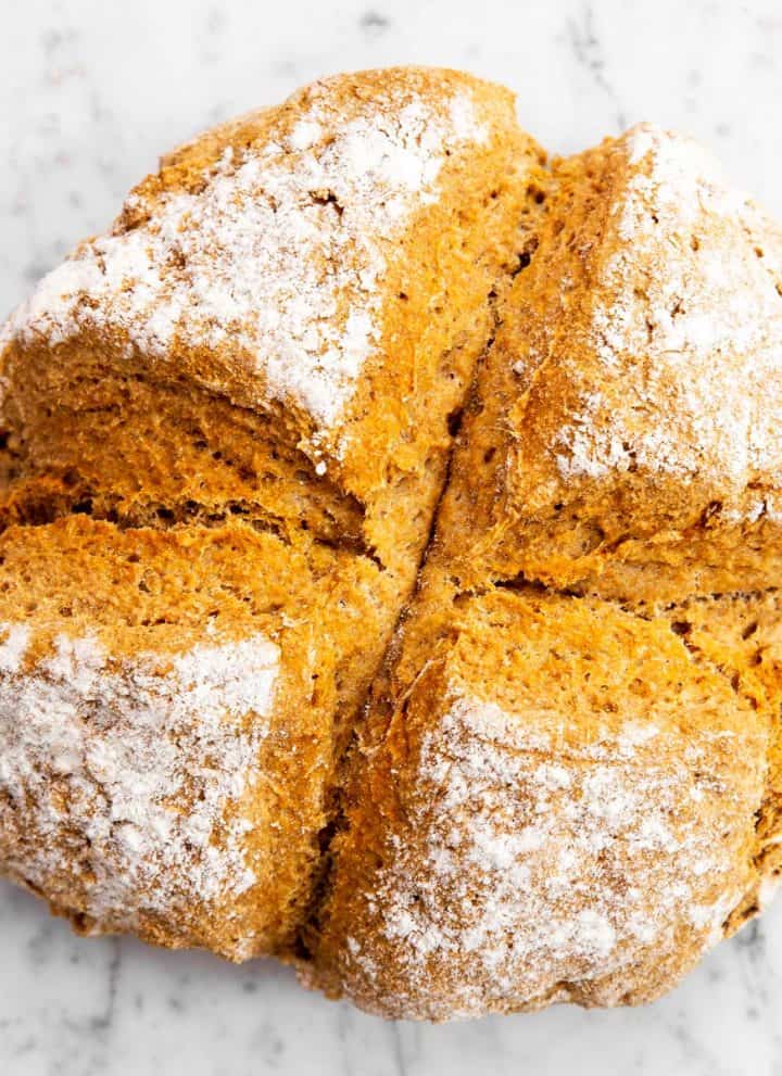 overhead view of baked Irish soda bread on marble surface