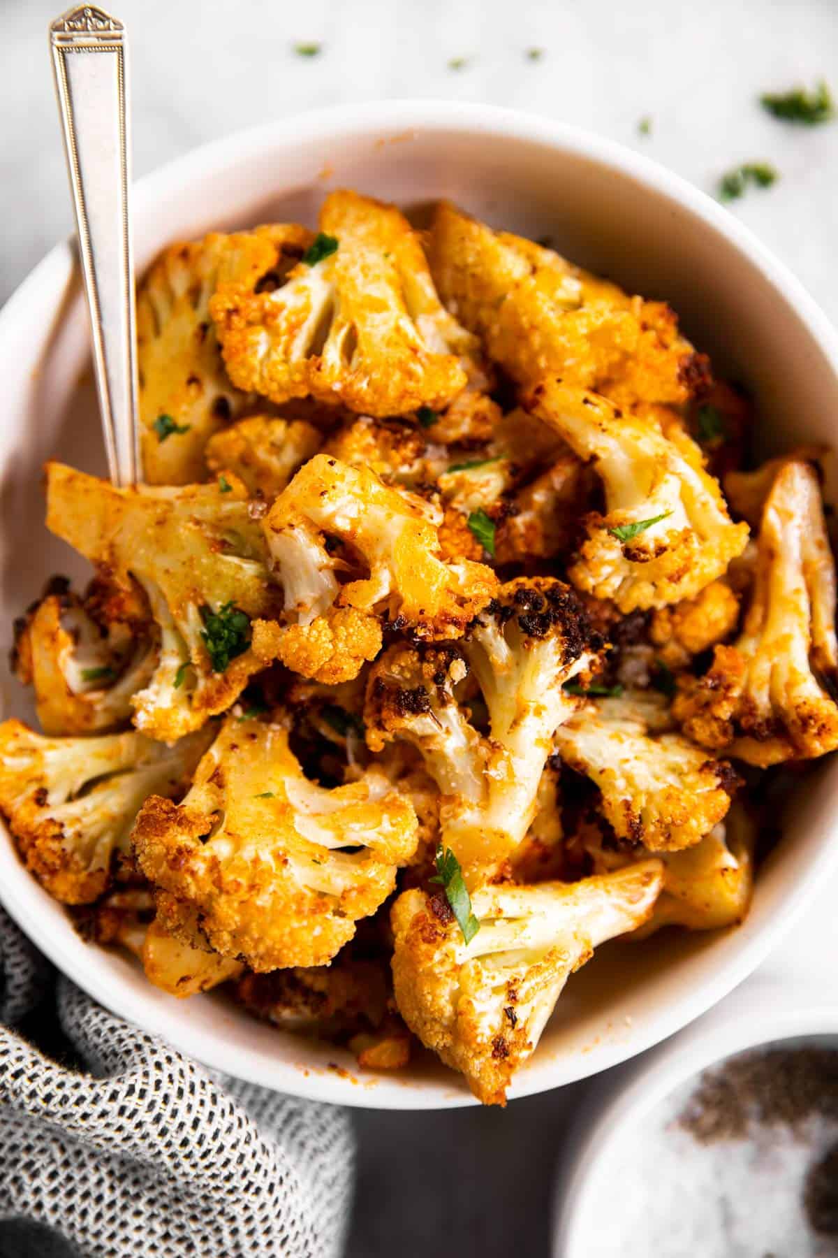 overhead view of air fried cauliflower in white bowl