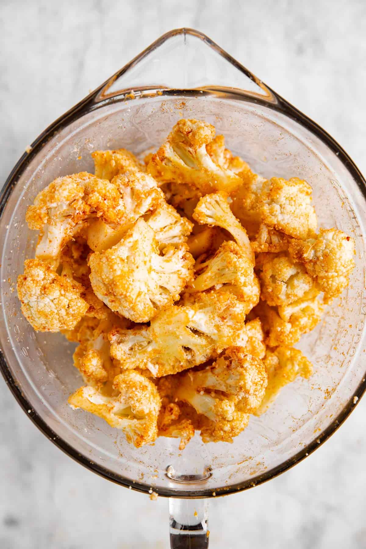 seasoned cauliflower in glass bowl