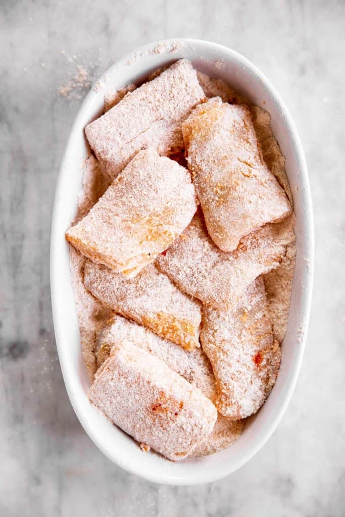 floured fish fillets in white dish