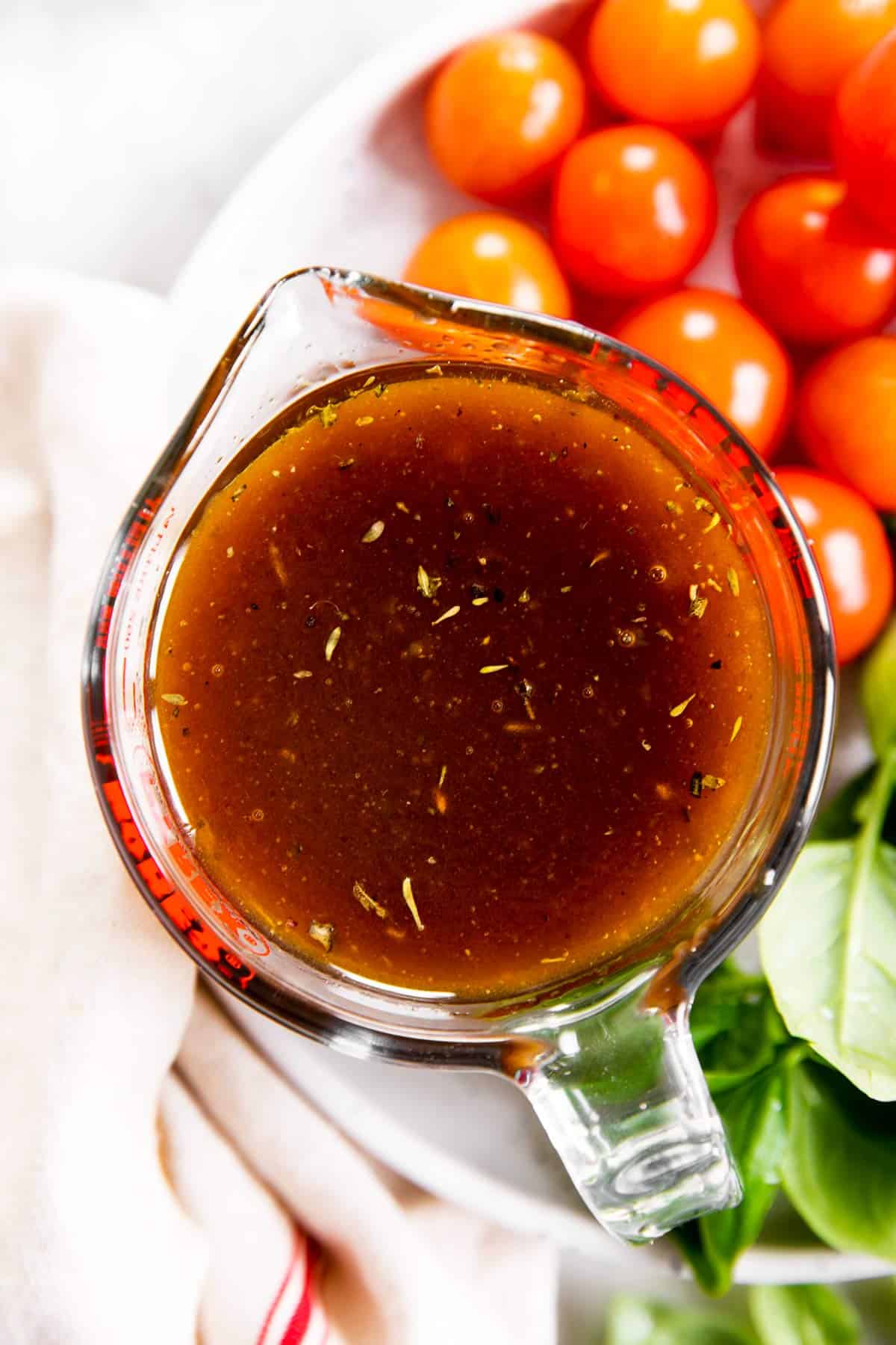 overhead view of balsamic vinaigrette dressing in glass measuring jug