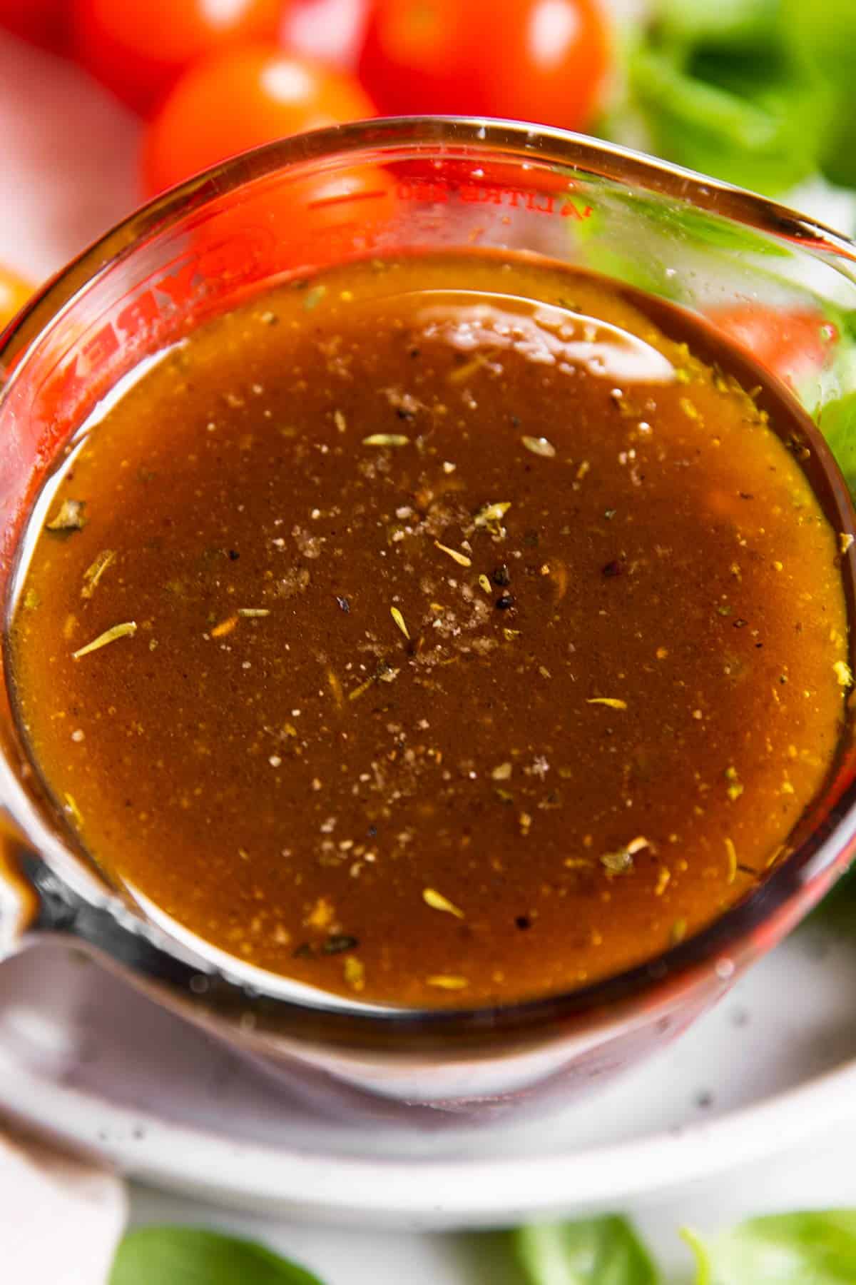 close up photo of balsamic vinaigrette in glass measuring jug