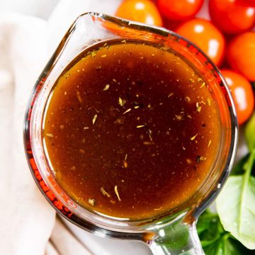 overhead view of balsamic vinaigrette dressing in glass measuring jug