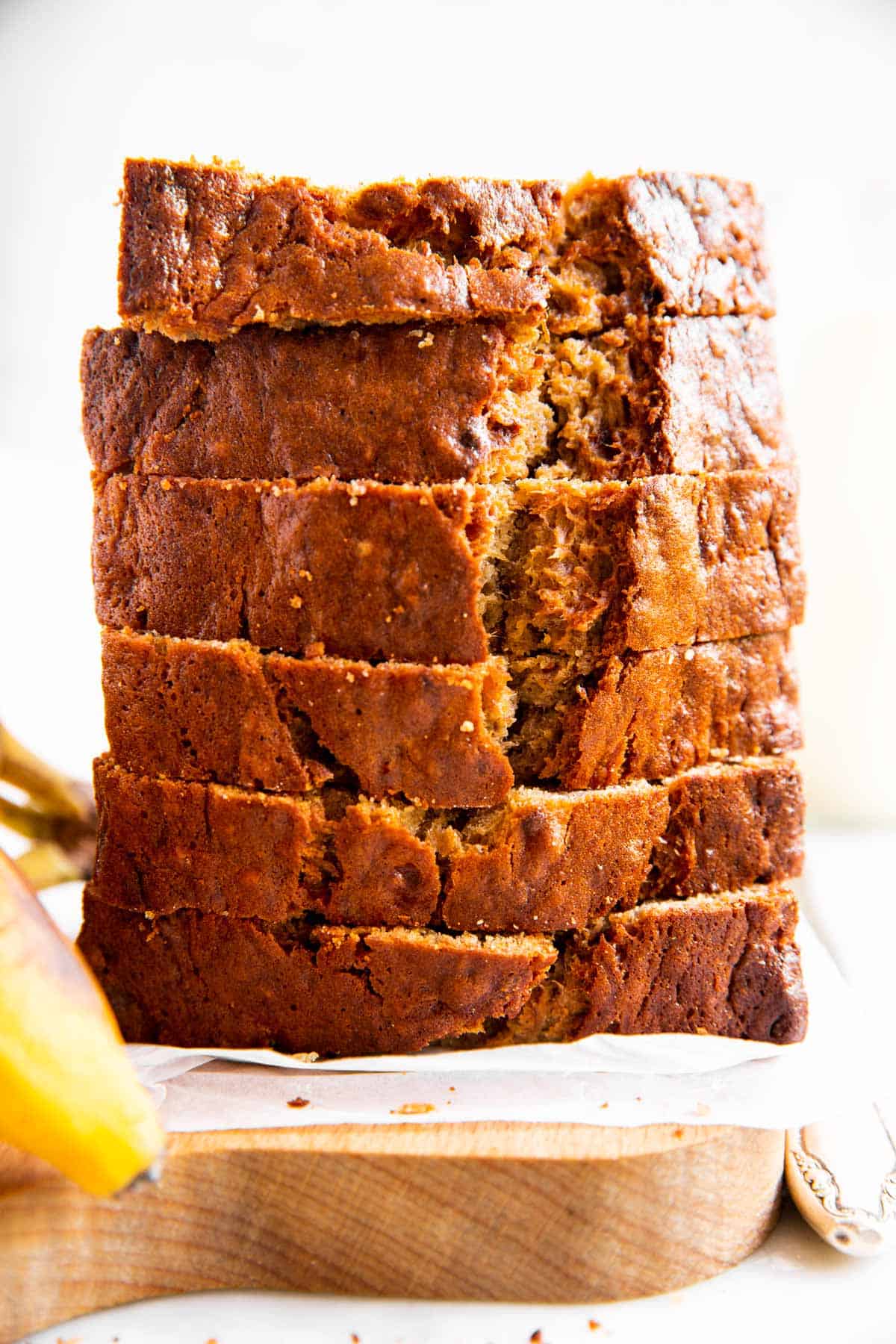 stack of sliced banana bread on wooden board