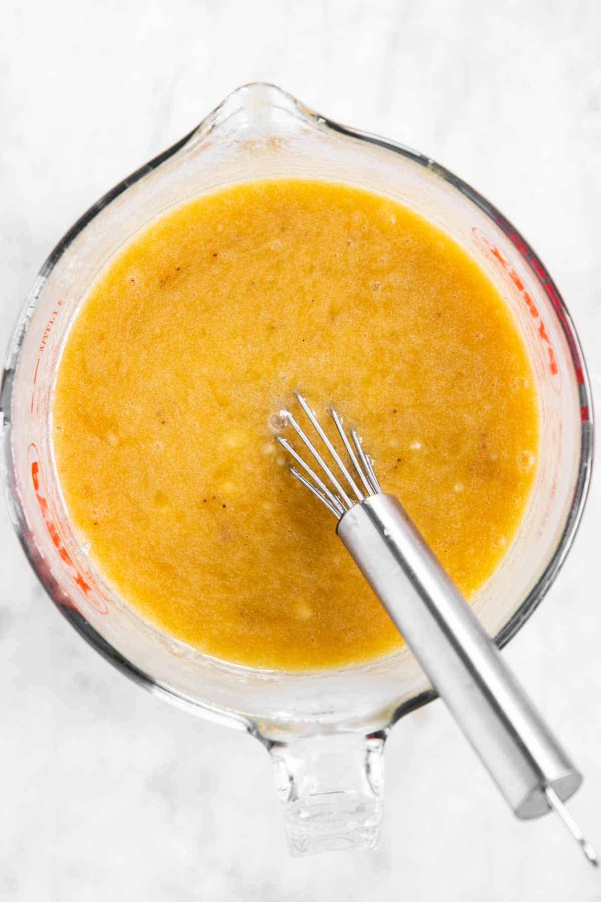 glass measuring jug with wet ingredients for banana bread